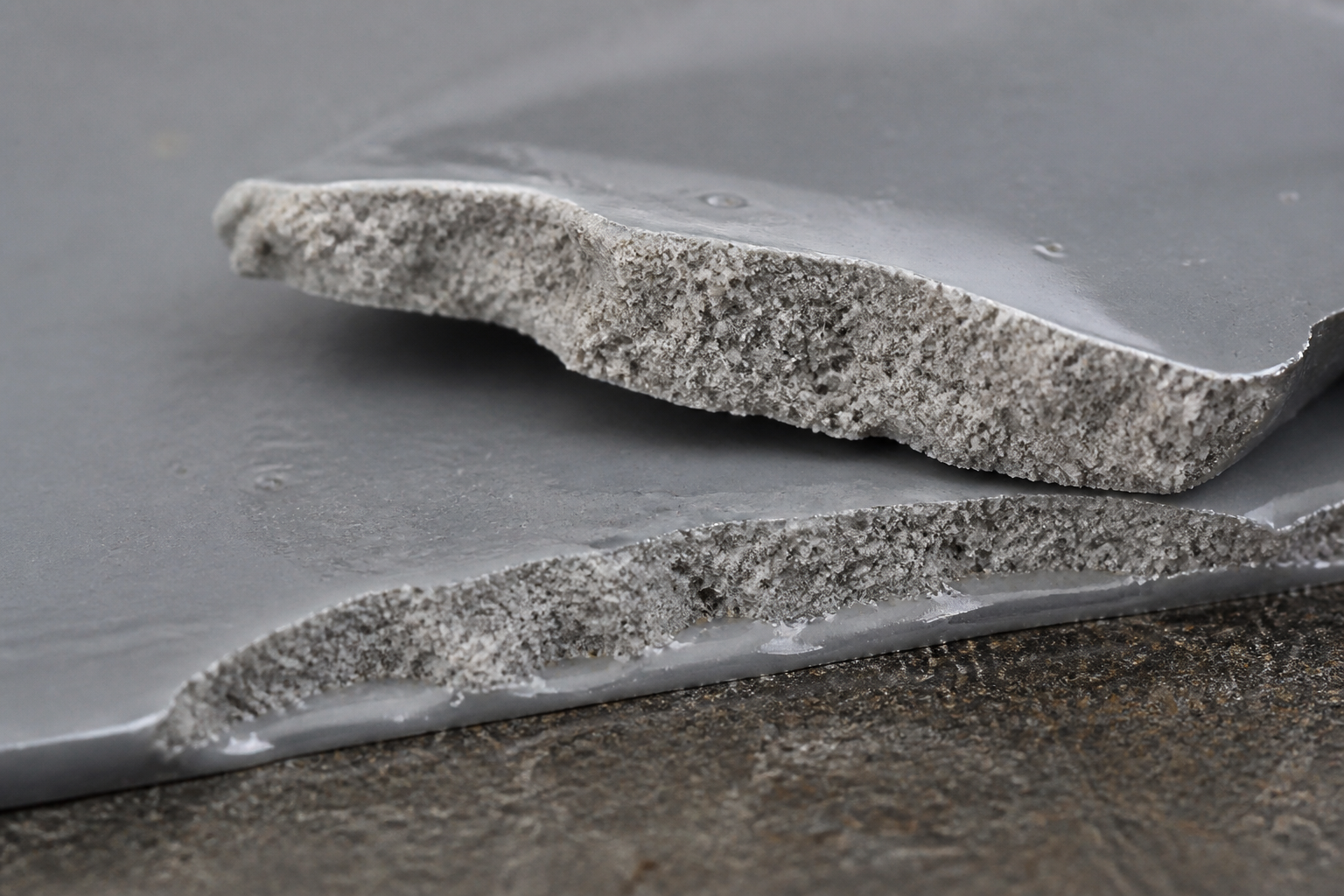 Photorealistic illustrative reference showing cohesive failure on a protective coating system
