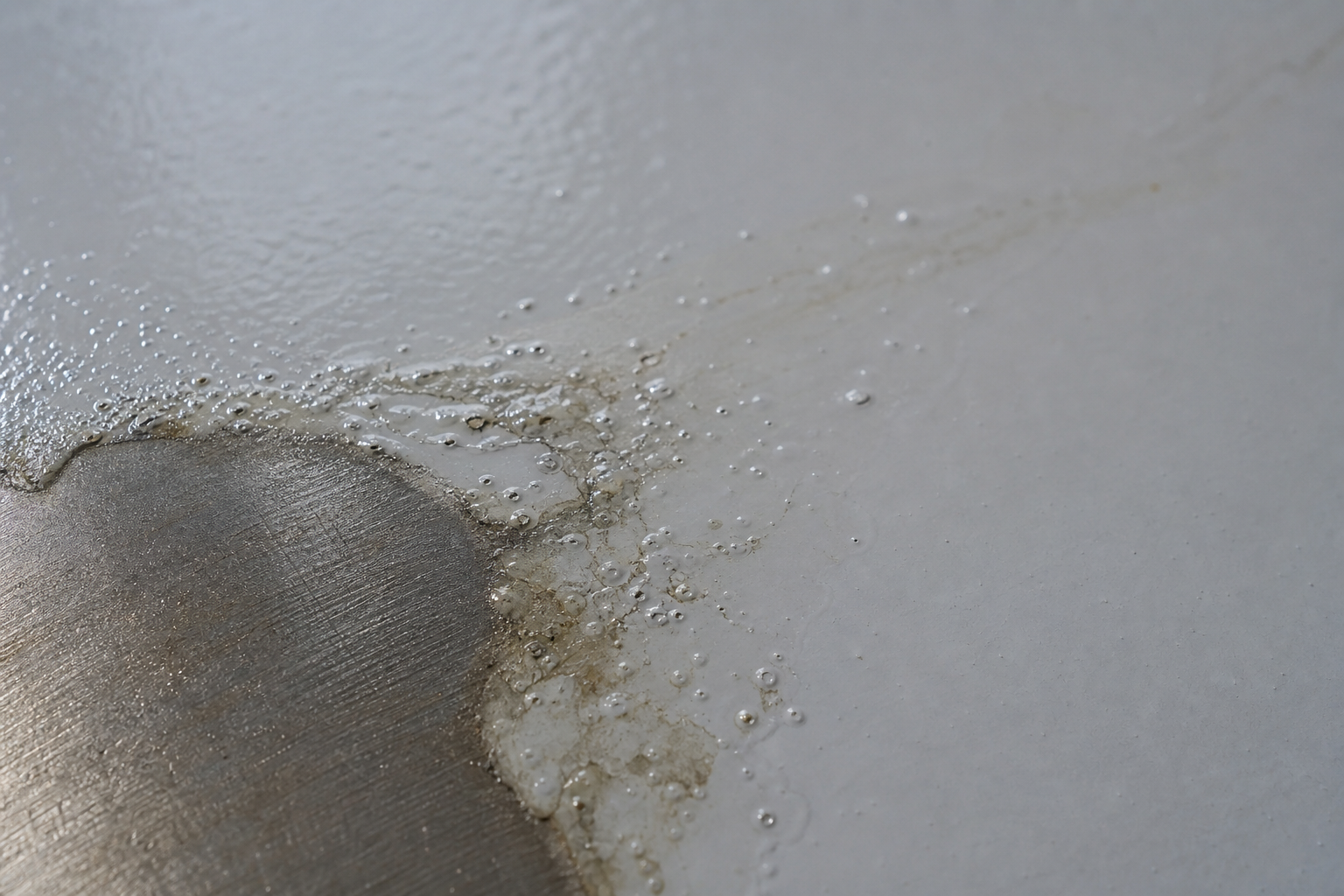 Photorealistic illustrative reference showing contamination failure on a protective coating system