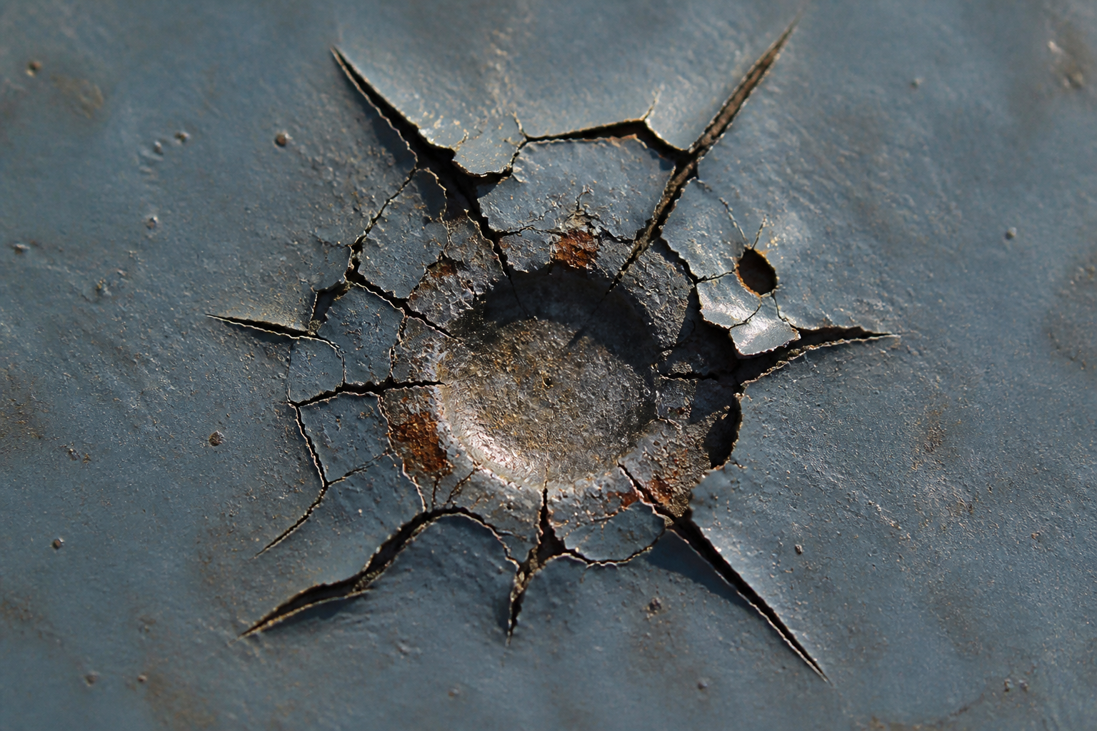Photorealistic illustrative reference showing impact damage on a protective coating system