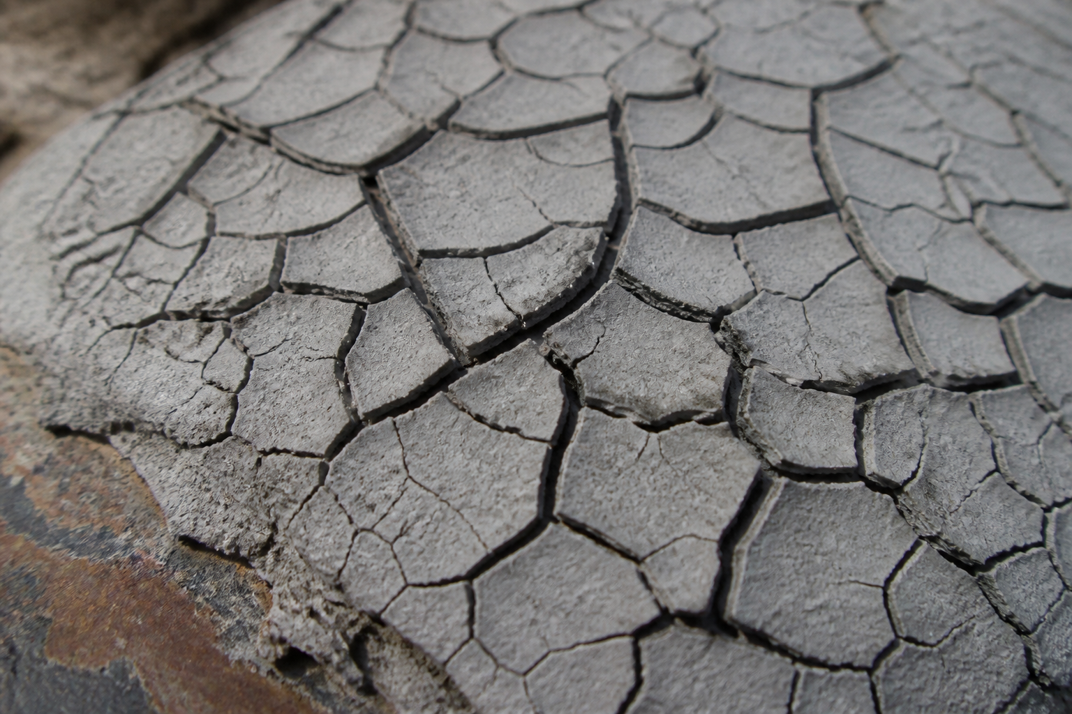 Photorealistic illustrative reference showing mud cracking on a protective coating system
