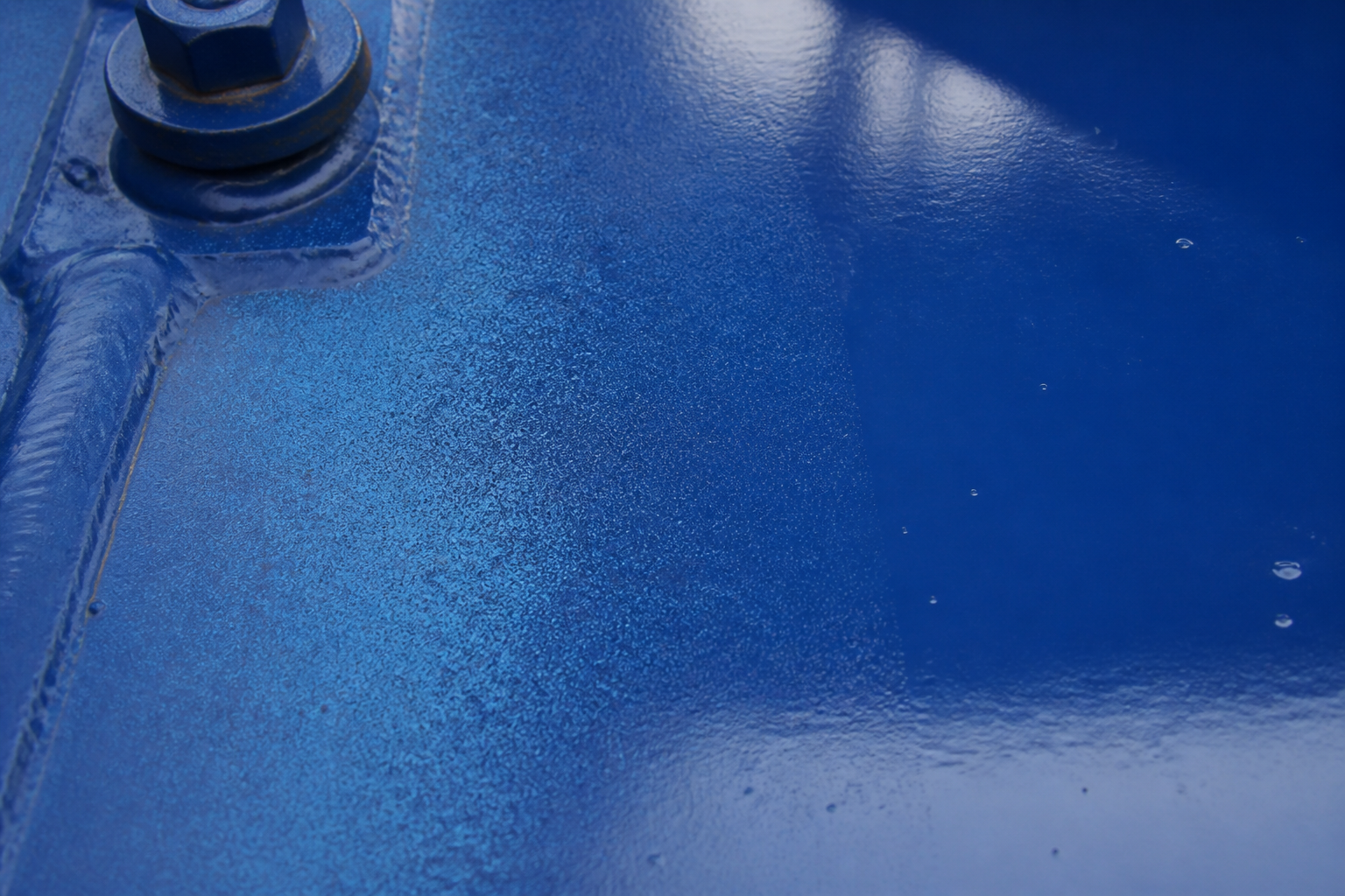 Photorealistic illustrative reference showing overspray on a protective coating system