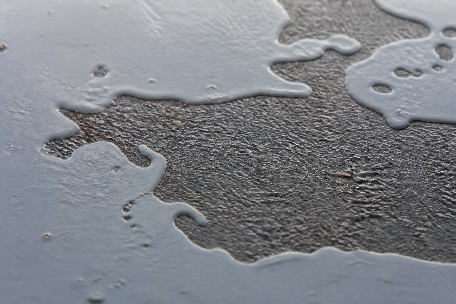 Photorealistic illustrative reference showing poor wetting on a protective coating system