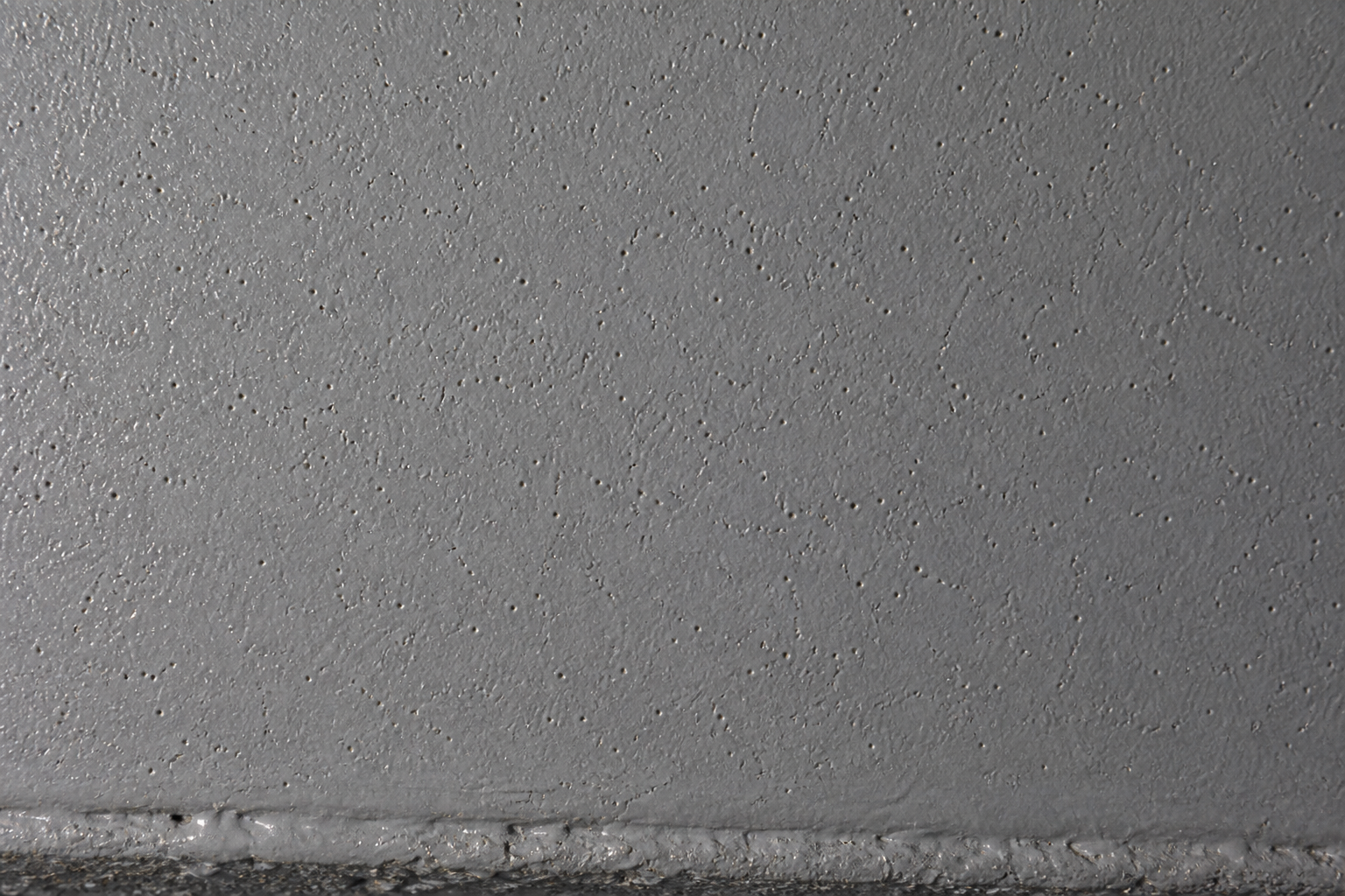 Photorealistic illustrative reference showing porosity on a protective coating system