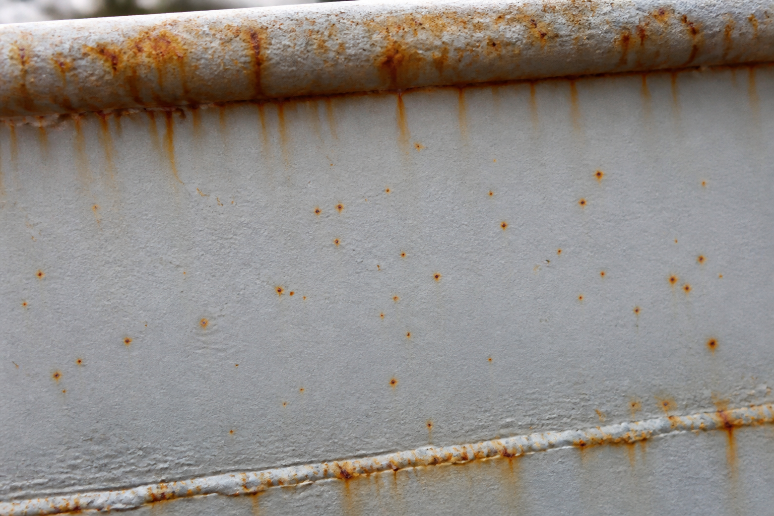 Photorealistic illustrative reference showing premature rusting on a protective coating system