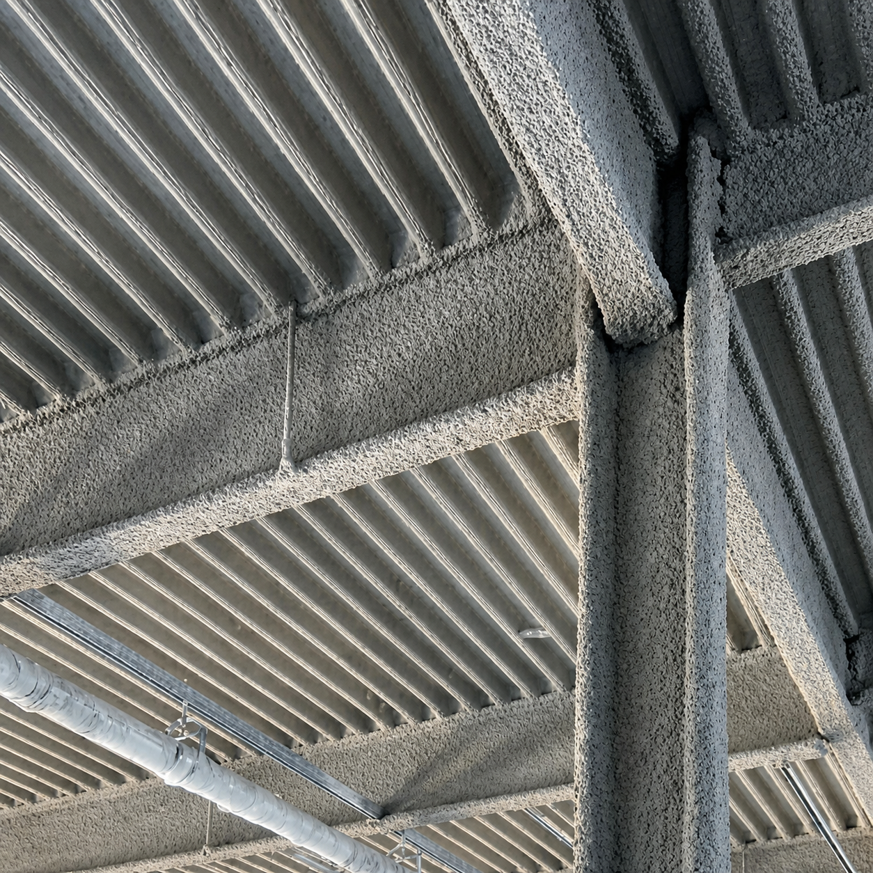 Protective coating applied to structural steel framing and metal decking